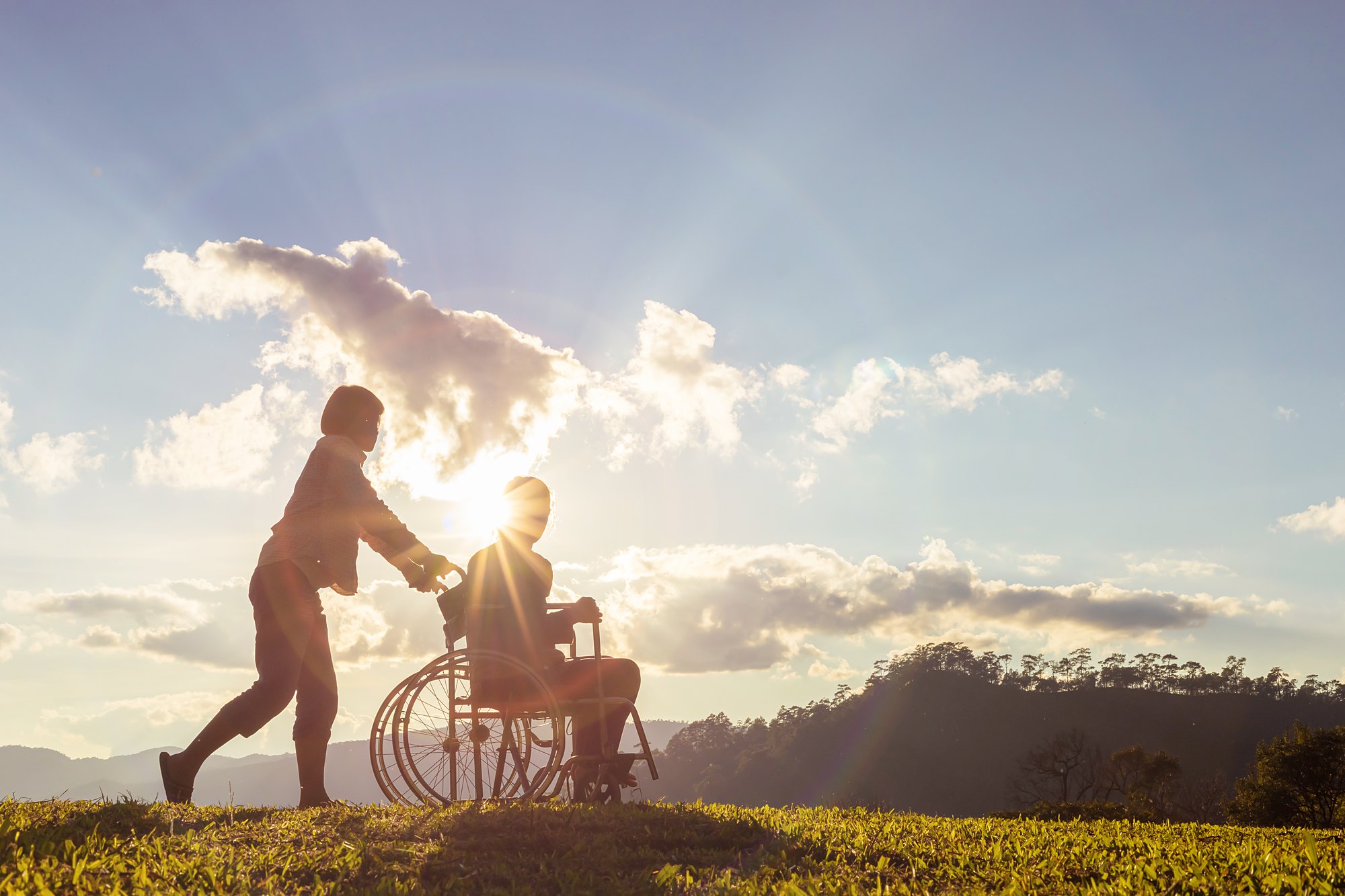A caregiver and a resident outdoors at the end of the day